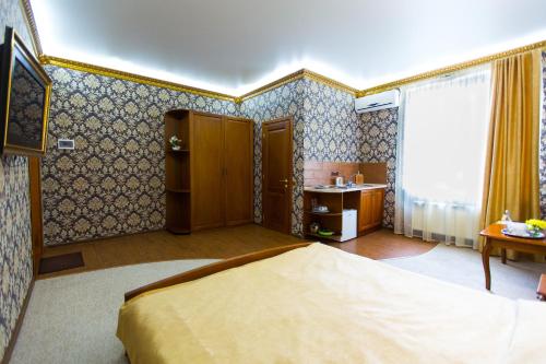a bedroom with a bed and a sink in it at Apart Hotel Clumba in Odesa