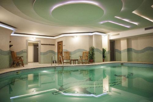 a large swimming pool with a domed ceiling at Bilek Istanbul Hotel in Istanbul