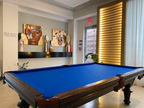 a billiard room with a blue pool table at Marseilles Beachfront Hotel in Miami Beach