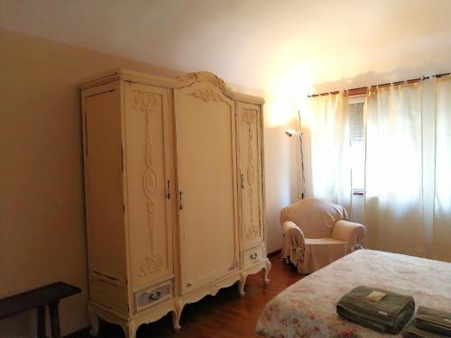 a bedroom with a large cabinet and a chair at Pane&Burro in Vercelli