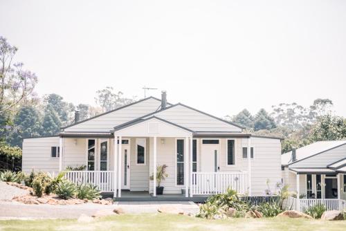 a white house with a black roof at Hampton Estate Wines in Mount Tamborine