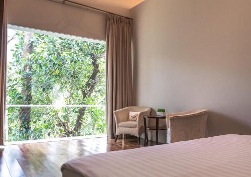 Postel nebo postele na pokoji v ubytování K Gallery Hotel