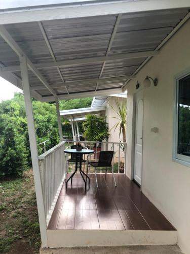 a patio with a table on a deck at ทับศิลารีสอร์ท Tubsila Resort in Chongsadao