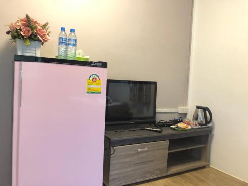 a refrigerator in a room with a tv at ทับศิลารีสอร์ท Tubsila Resort in Chongsadao