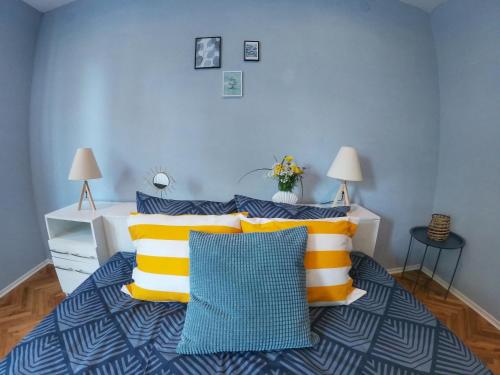 a bedroom with a bed with yellow and blue pillows at Into The BLUE, 4 guests, 5 min away from the BEACH in Varna City