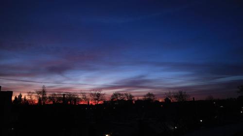 a sunset with a blue and red sky at Peking Youth Hostel in Beijing