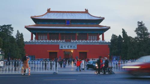 a large red building with people walking in front of it at Peking Youth Hostel in Beijing