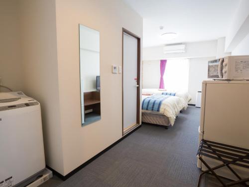Кровать или кровати в номере Hotel Peace Island Nago