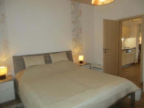 a bedroom with a bed and two lamps on tables at Ferienwohnung Schrammsteine in Bad Schandau