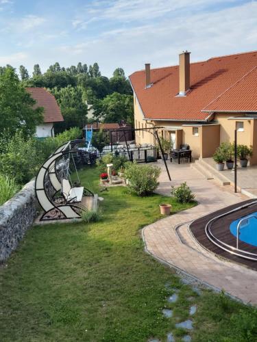 an image of a backyard with a playground at Római Apartman in Badacsonytomaj