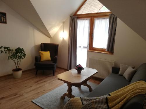 a living room with a couch and a table at Penzion Centrum in Sklené Teplice