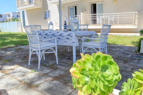 a table and chairs and a plant on a patio at MARIMAR - Apartments OTRANTO in Otranto