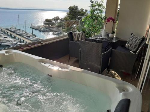 a bath tub with a view of the ocean at Apartments Sax in Crikvenica