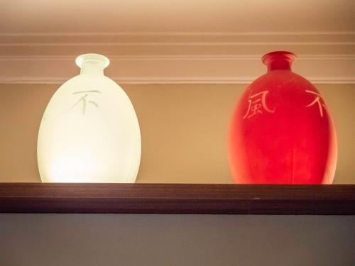 three vases sitting on top of a shelf at Pension Ciudadela in Barcelona