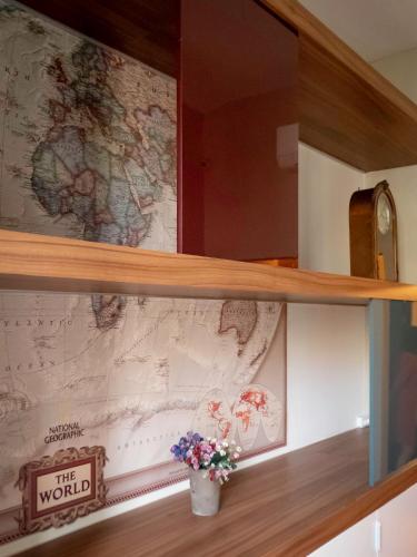 a wooden shelf with a map on a wall at Pension Ciudadela in Barcelona