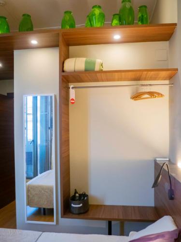a bunk bed in a room with green vases at Pension Ciudadela in Barcelona