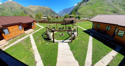 an aerial view of a yard with a house and a playground at Hotel Migu Yard in Stepantsminda