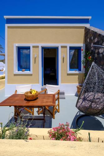 a house with a table and a basket of fruit at Pasithea Suites in Megalokhori