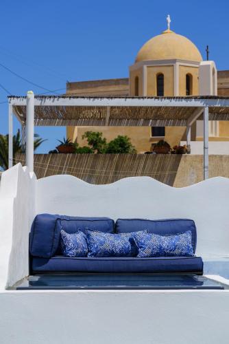 a blue couch sitting on top of a building at Pasithea Suites in Megalokhori