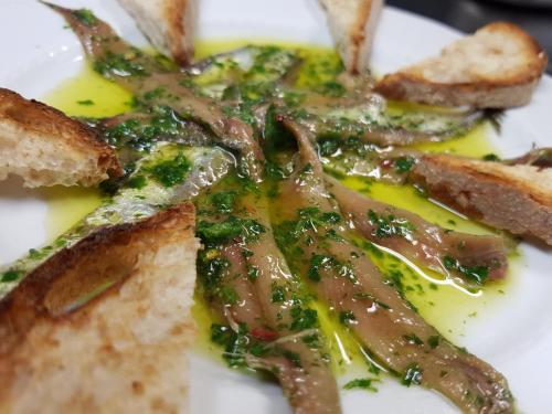 a plate of food with meat and bread with sauce at Certosa 1515 in Avigliana
