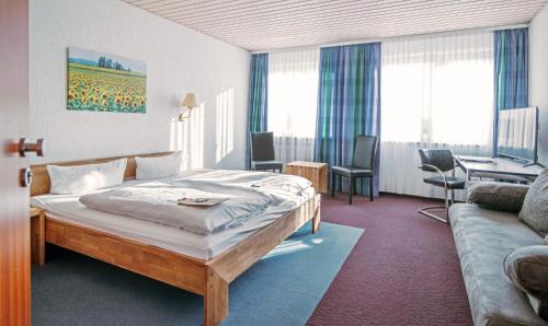 A bed or beds in a room at Landhotel Klingerhof