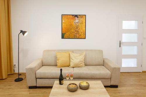a living room with a couch and a table at Apartments Villa Whitehouse in Ostrava