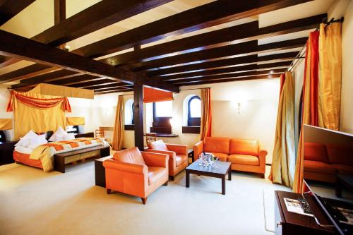 a living room with a bed and a couch at Burg & Gästehaus by Schwarzenstein in Geisenheim