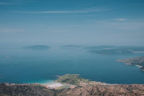 an island in the middle of a body of water at Casa de Santa Uxía in Ézaro
