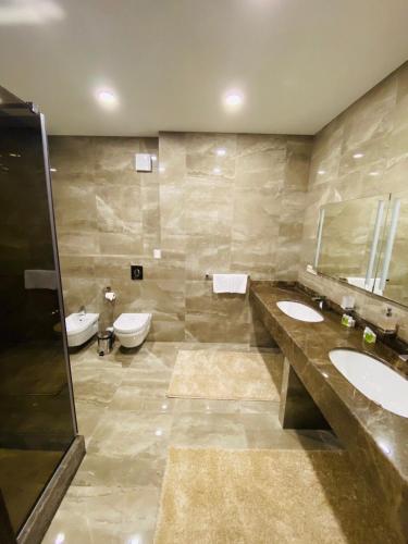 a bathroom with two sinks and two toilets at Maristella Marine Residence in Odesa
