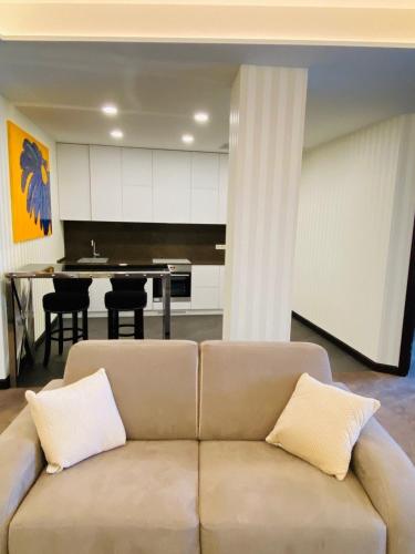 a living room with a couch and a kitchen at Maristella Marine Residence in Odesa