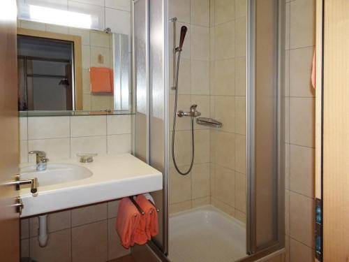a bathroom with a sink and a shower at Apartments Albana in Saas-Fee