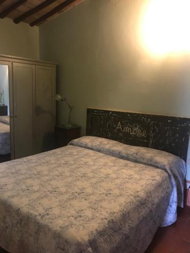 a bedroom with a bed and a dresser at La Locanda del Loggiato in Bagno Vignoni