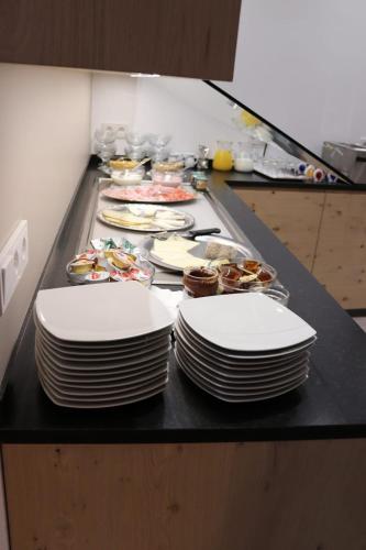 a bunch of plates sitting on a counter with food at Appartements Eppanerhof in Appiano sulla Strada del Vino