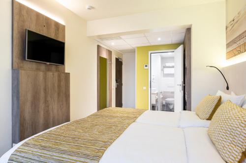 Een bed of bedden in een kamer bij Mercure Oostende