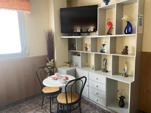 a dining room with a table and a tv at Hotel Arce in San Pedro del Pinatar