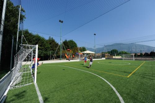 a group of people playing soccer on a soccer field at Camping Del Sole Village in Iseo