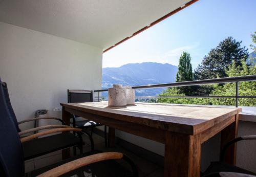 a table and chairs on a balcony with a view at Apartments Drei Türme by Pferd auf Wolke in Schruns-Tschagguns