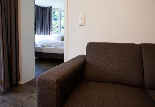 a living room with a couch and a bedroom at Apartments Drei Türme by Pferd auf Wolke in Schruns-Tschagguns