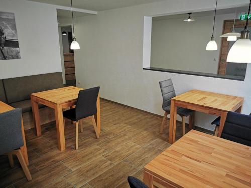 a meeting room with wooden tables and chairs at Pension unterm Schlossturm in Haag in Oberbayern