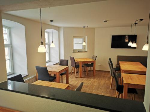 a dining room with wooden tables and chairs at Pension unterm Schlossturm in Haag in Oberbayern