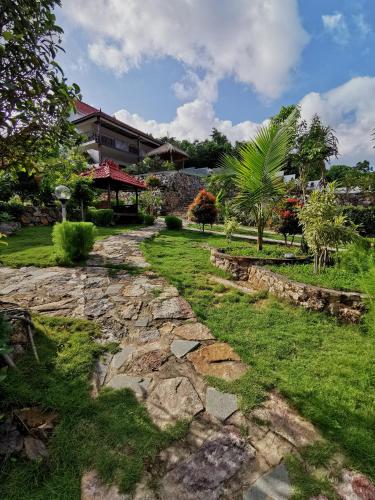 a stone path in front of a house at Mirabelle Joglo Village in Karimunjawa
