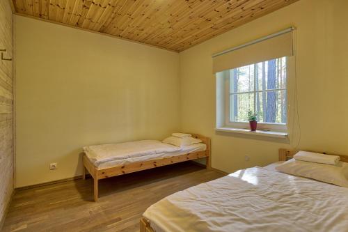a room with two beds and a window at Roostasalu Holiday home in Elbiku