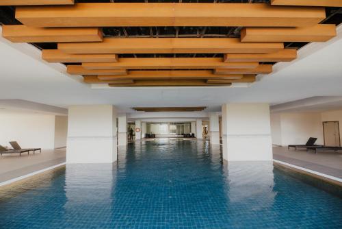 a pool in a building with a wooden ceiling at 231TR by the Betty Roux Heritage in Kuala Lumpur