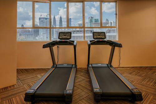 two treadmill machines in a room with a window at 231TR by the Betty Roux Heritage in Kuala Lumpur