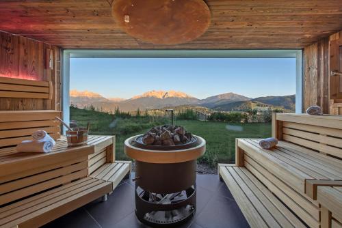 a sauna with a large window with a view at Panoramahotel Obkircher in Nova Ponente