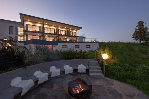 a house with a fire pit in front of it at Panoramahotel Obkircher in Nova Ponente