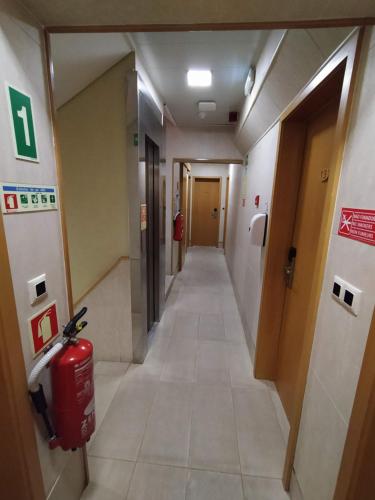 a hallway in a hospital with a fire hydrant in it at Hotel Botanico in Lisbon