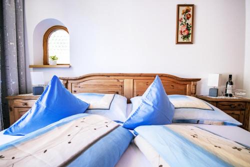 a bedroom with two beds with blue pillows at Haus Wulfenia in Neustift im Stubaital