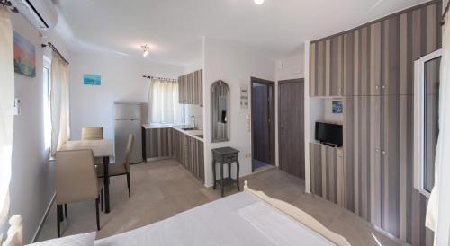 a small room with a kitchen and a dining room at Boursinos cozy apartments in Lefkada Town