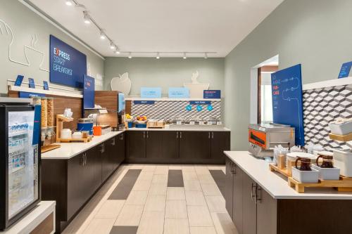 a store interior with counters and a food store at Holiday Inn Express Hotel & Suites Fort Myers East - The Forum by IHG in Fort Myers